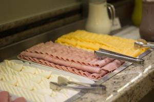 a tray of ham and cheese on a counter at Hotel Regina Rio de Janeiro in Rio de Janeiro