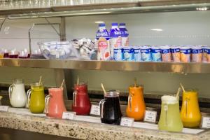 a shelf with many different colored glass vases at Hotel Regina Rio de Janeiro in Rio de Janeiro