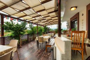 a restaurant with tables and chairs on a patio at Ephesus Palace in Selcuk