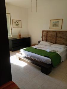 En eller flere senger på et rom på Casa Vacanze Del Carrubo