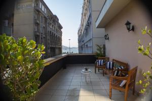 a balcony with chairs and a table on a building at Hotel Regina Rio de Janeiro in Rio de Janeiro
