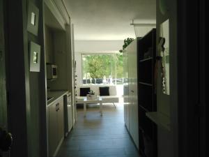 a hallway with a kitchen and a living room at Laura Sunbeach in Alcudia