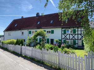 a white house with a white picket fence at Buxhaus in Solingen
