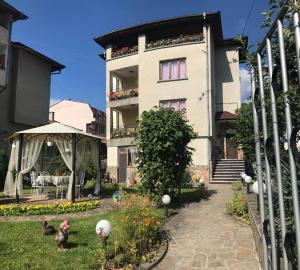 a building with a garden in front of it at Guest House Detelina in Devin