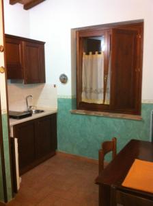 una cucina con lavandino e specchio di Country House Il Piancardato a Collazzone