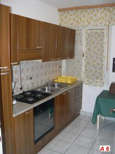 a kitchen with a sink and a stove top oven at Apartmani David in Pula