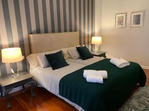 a bedroom with a large bed with two towels on it at Apartamento Murrieta in Logroño