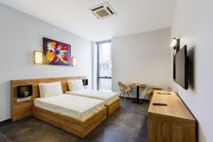 a bedroom with a bed and a tv and a desk at G Suites Luxury Rentals in North Nicosia