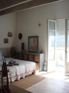 um quarto com uma cama e uma porta de vidro deslizante em la maison de Carol em Le Beausset
