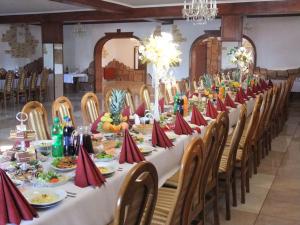 a long table with plates of food on it at Hotel Pod Jaskółką in Zagnańsk