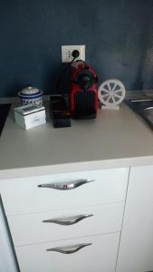 a kitchen counter with a white cabinet with silver handles at A due passi dal mare in Marina di Carrara +4 photos