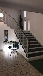 a stairway with a table and a chair in a room at Hôtel Vulcain in LʼHorme