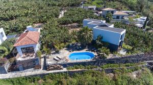 an aerial view of a house with a swimming pool at Quinta Golfinho in Arco da Calheta