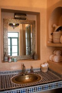 a bathroom with a sink and a mirror at Riad Orange in Marrakech