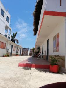 a building with a red stripe on the side of it at Manzanillo Beach in Cartagena de Indias