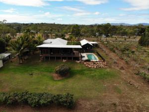 an aerial view of a house with a swimming pool at Birds Heaven Mareeba in Mareeba