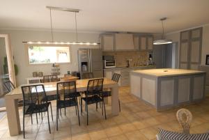 a large kitchen with a table and chairs in it at Villa Jamy Roaix avec piscine in Roaix