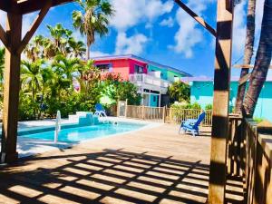 a swimming pool with blue chairs next to a building at Conch Key Fishing Lodge & Marina in Conch Key