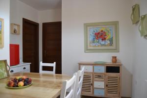 a dining room with a table and a bowl of fruit at Nuscos Bed and Breakfast in Nuoro