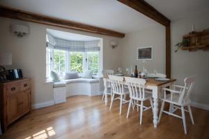 a dining room with a table and chairs and a window at Westgate Lodge at Dedham in Dedham