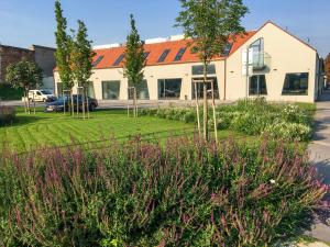 a house with a garden in front of it at Penzión Elements in Trnava
