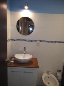 a bathroom with a sink and a mirror and a toilet at Carmelo RIVERSIDE Bungalows in Carmelo +78 photos