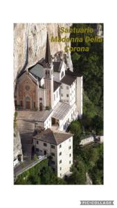 a picture of a church with a mountain in the background at LULLABY HOUSE LAZISE in Lazise