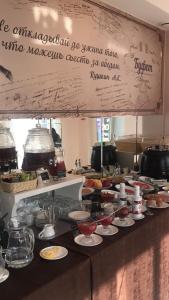 a buffet line with dishes of food on a table at VEGA Hotel in Arkhangelsk