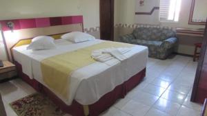 a bedroom with a large bed and a couch at Inter Park Hotel in Ponta Porã +30 photos