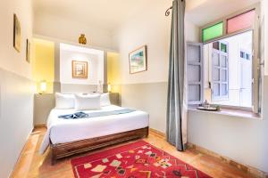 a bedroom with a bed and a window at Riad Laila in Marrakesh