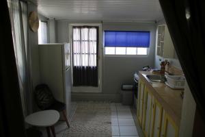 a small kitchen with a sink and a refrigerator at Coral Reef Beach in Savaneta