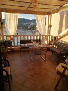 a porch with a table and a view of the water at Apartments Paradiso in Budva