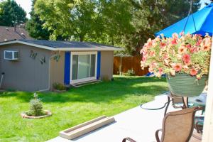 a yard with a pot of flowers and a house at Blue Bear Den 3BR 2BA DTC Private Apt Hot Tub in Denver