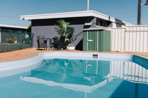 a swimming pool in the backyard of a house at Tamworth City Motel in Tamworth