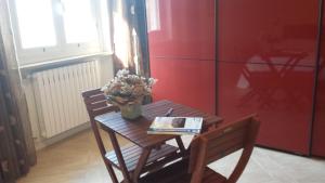 a table with a book and flowers on it at B&B Azzurra in Pescara