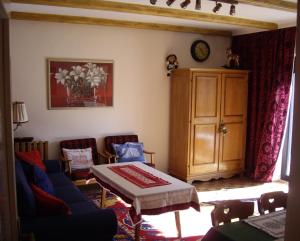 a living room with a blue couch and a table at Apartment Sophia in Seefeld in Tirol