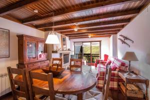 a living room with a wooden table and a couch at NOGUERA de Alma de Nieve in Baqueira-Beret
