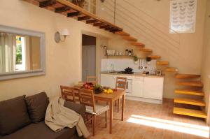 a living room with a couch and a table and a kitchen at Podere Calledro in Narni