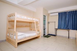 a bedroom with two bunk beds in a room at Semrock Hotel 仙乐酒店 in Semporna