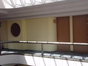 an empty room with a railing in a building at Hotel Plaza Las Fuentes in Puebla