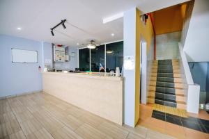 a lobby with a counter and a staircase in a building at Semrock Hotel 仙乐酒店 in Semporna