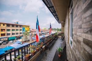 a balcony of a hotel with tables and flags at Semrock Hotel 仙乐酒店 in Semporna