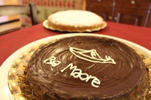 a chocolate cake on a plate on a table at Hotel Bia Maore in Baunei