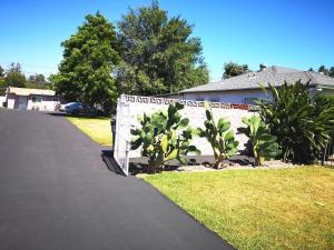 a house with a sign on the side of a driveway at Pasadena single house in Pasadena