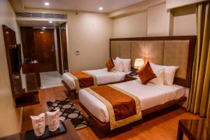 Postel nebo postele na pokoji v ubytování Hotel Indo Prime