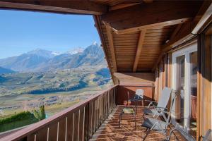 a balcony with chairs and a view of mountains at Appartment Maria in Schenna