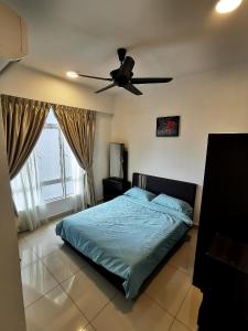 a bedroom with a bed and a ceiling fan at Cozy Ipoh Homestay in Ipoh