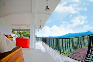 a room with a balcony with a view of mountains at Romance Hills Hotel in Kandy
