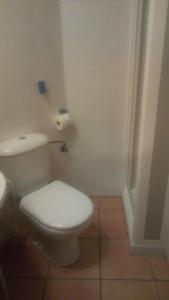 a bathroom with a white toilet and a roll of toilet paper at Oliva Nova Golf in Oliva +30 photos