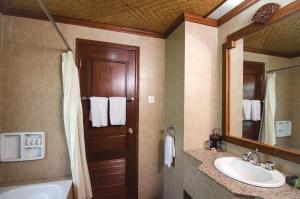a bathroom with a sink and a toilet and a mirror at Sri Phala Resort & Villa in Sanur